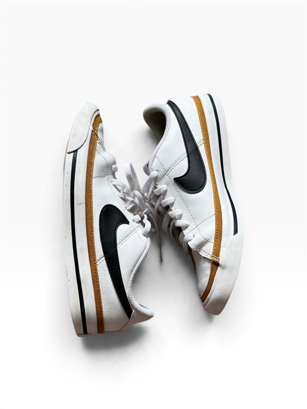 Nike Women's White Sneakers with Black Swoosh and Brown Accent